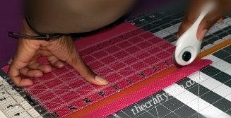 Cutting fabric using the self healing mat, rotary cutter, and ruler.